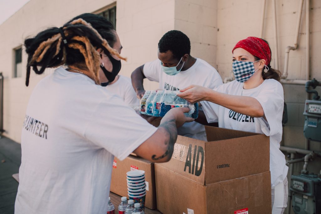 two doctors handing out supplies to the community