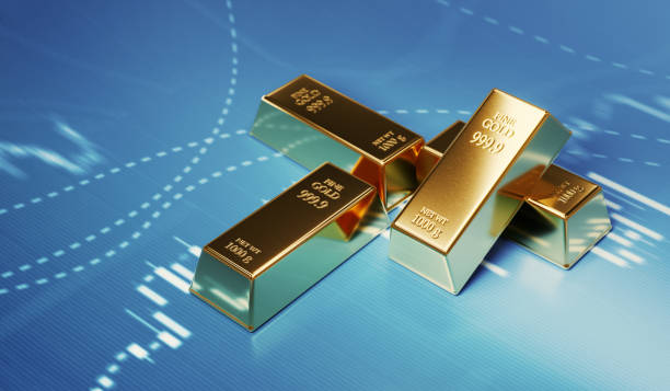Gold bars sitting in front of a price fluctuation chart